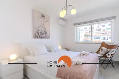 a white bedroom with a bed and a window at #317 Edificio Linda Vista by Home Holidays in Albufeira