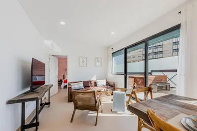 a living room with a table and chairs and a piano at Terra X Apartments in Faro