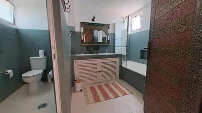 a bedroom with two beds and a large window at La Balaia - charm and comfort 12 people 9 beds in Albufeira