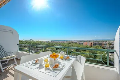 a white table with food on top of a balcony at Salgados Sunset and Sea View Apartment in Guia