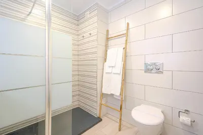 a bathroom with a toilet and a shower at Salgados Sunset and Sea View Apartment in Guia