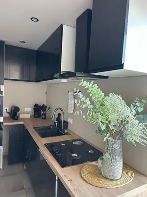 a kitchen counter with a vase with a plant on it at Beach penthouse paradise T4 in Quarteira