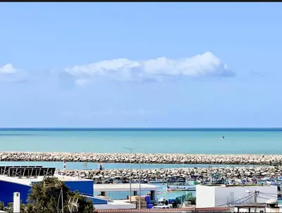 a beach with a lot of sand and the ocean at Beach penthouse paradise T4 in Quarteira