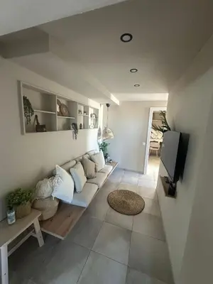 a living room with a couch and a tv at Beach penthouse paradise T4 in Quarteira
