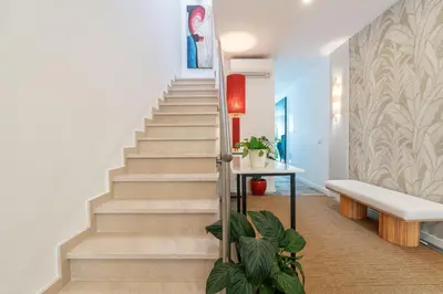 a staircase in a house with a bench and plants at Casa Bella in Faro