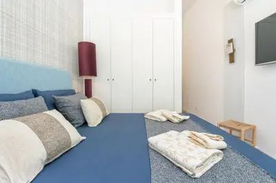 a bedroom with a bed with towels on the floor at Casa Bella in Faro