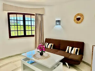 a living room with a couch and a table at Villa SOLAR DO MONTE 5 in Albufeira