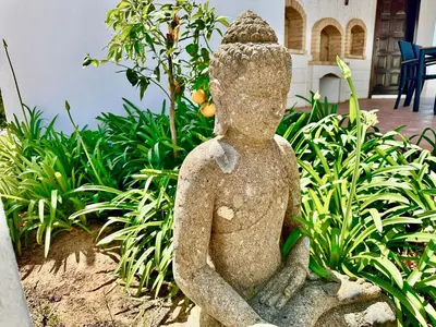 a statue of a person sitting in a garden at Villa SOLAR DO MONTE 6 in Albufeira