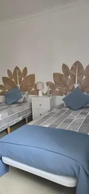 a bedroom with two beds with blue pillows at Quinta Do Vale 32 by AL in Guia