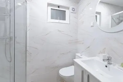 a bathroom with a toilet and a sink and a mirror at Albufeira Old Town Apartment in Albufeira
