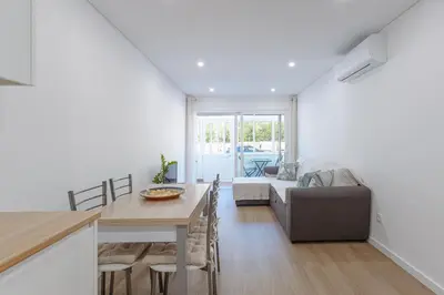 a kitchen with white cabinets and a refrigerator at Albufeira Old Town Apartment in Albufeira
