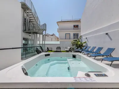 a hot tub on the balcony of a building at Holiday Home Nannoush - Vip Properties by Interhome in Albufeira