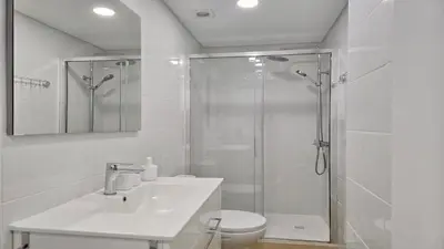 a bathroom with a shower and a sink and a toilet at Tenis Golf Mar A209 - CD 309 - Sleeps 2 adults and 2 children in Vilamoura