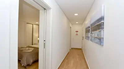 a hallway leading to a bedroom with a bed at Tenis Golf Mar A209 - CD 309 - Sleeps 2 adults and 2 children in Vilamoura
