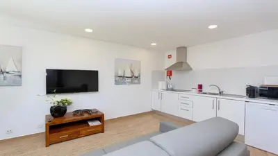 a living room with a couch and a kitchen at Tenis Golf Mar A209 - CD 309 - Sleeps 2 adults and 2 children in Vilamoura