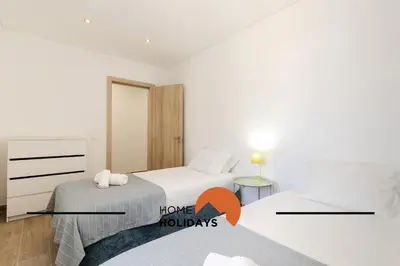 a bedroom with two beds and a room with a house melody at #331 Casa Chico Rita by Home Holidays in Sesmarias