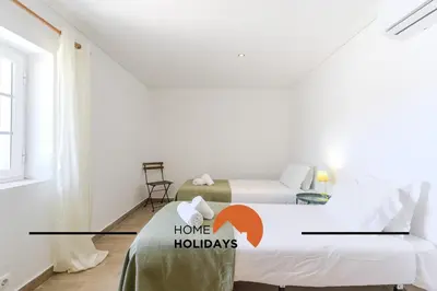 a room with two beds and a sign that says home holidays at #331 Casa Chico Rita by Home Holidays in Sesmarias