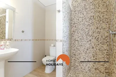 a bathroom with a sink and a toilet and a mirror at #331 Casa Chico Rita by Home Holidays in Sesmarias