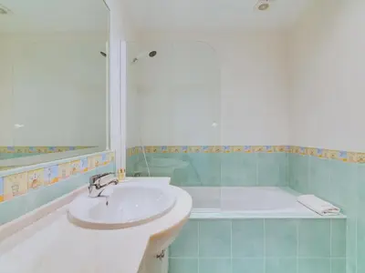 a bathroom with a sink and a bath tub at 1 bdr apartment with pool next to Laguna Golf Course in Vilamoura