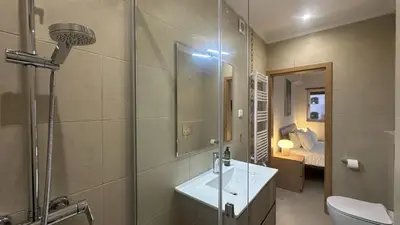 a bathroom with a shower and a sink and a toilet at Figo by Check-in Portugal in Quarteira