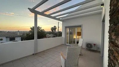 a patio with chairs and a roof at Figo by Check-in Portugal in Quarteira