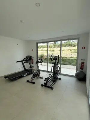 a gym with three exercise bikes in a room at Casa Verde in Albufeira