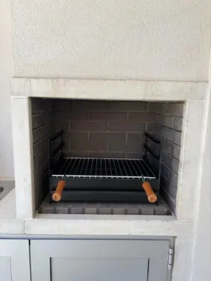 a brick oven with a rack inside of it at Casa Verde in Albufeira