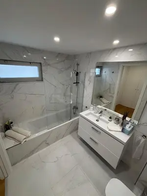 a bathroom with a shower and a sink and a tub at Casa Verde in Albufeira