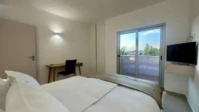 a bedroom with a bed and a desk and a television at Amêndoa by Check-in Portugal in Quarteira