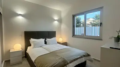 a bedroom with a large bed with two lamps at Amêndoa by Check-in Portugal in Quarteira