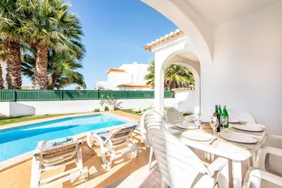 a patio with a table and chairs next to a swimming pool at Villa Julia Gale in Guia