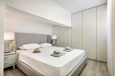 a bedroom with a large white bed with two hats on it at Villa Melvin in Quarteira