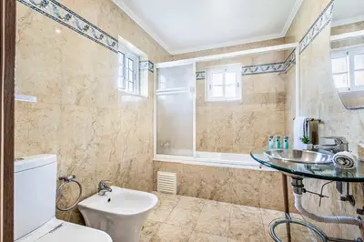 a bathroom with a toilet and a sink and a shower at Villa Casanova Golf in Quarteira