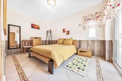 a living room with a couch and a tv at Villa Sunflower in Albufeira