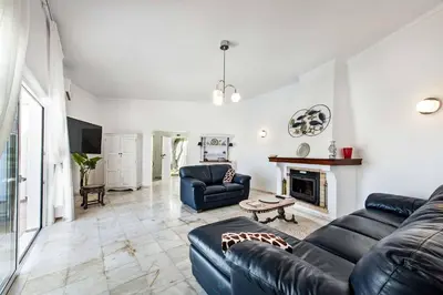 a living room with a couch and a fireplace at Villa Barbara in Albufeira