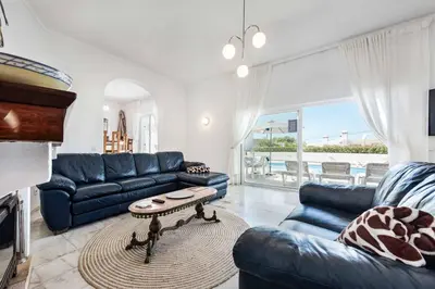 a living room with a blue couch and a table at Villa Barbara in Albufeira