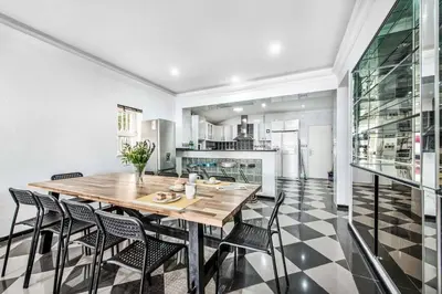 a dining room with a wooden table and chairs at Villa Mogan in Albufeira