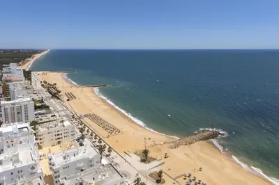 an aerial view of a beach and the ocean at Terracos de Quarteira II Caribe by Real Properties in Quarteira