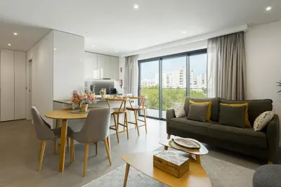 a living room with a couch and a table at Terracos de Quarteira II Caribe by Real Properties in Quarteira
