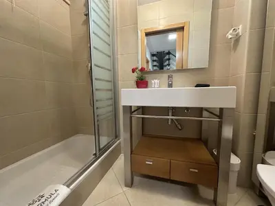 a bathroom with a sink and a shower at Monte da Vinha By FHR in Quarteira