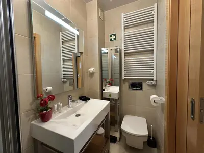 a bathroom with a sink and a toilet and a mirror at Monte da Vinha By FHR in Quarteira