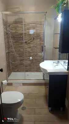 a bathroom with a shower and a toilet and a sink at Sun House in Albufeira