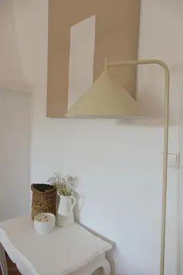a white table with two vases and a mirror at Manso da Falésia in Olhos de Água