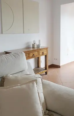 a living room with a table and a couch at Manso da Falésia in Olhos de Água