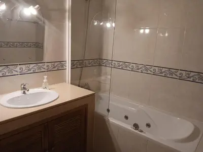 a bathroom with a sink and a shower and a tub at Albufeira Baixa Apartment in Albufeira