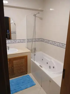 a bathroom with a tub and a sink at Albufeira Baixa Apartment in Albufeira
