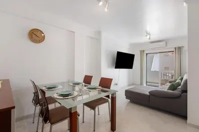 a living room with a table and a couch at Excellent Apartment in Olhos D´Água in Olhos de Água