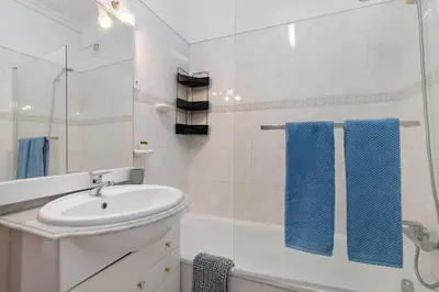 a bathroom with a sink and a mirror at Excellent Apartment in Olhos D´Água in Olhos de Água