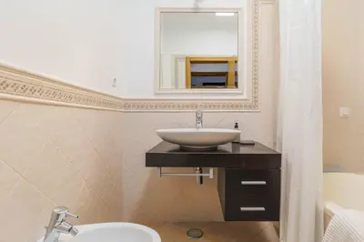 a bathroom with a sink and a mirror at Bright 3-BR in Guia with Shared Pool by Lisbeyond in Guia