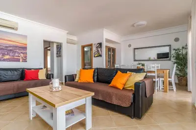 a living room with two couches and a table at Bright 3-BR in Guia with Shared Pool by Lisbeyond in Guia